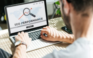 A person using a laptop to track SEO performance with a graph on the screen, illustrating hospice website growth.