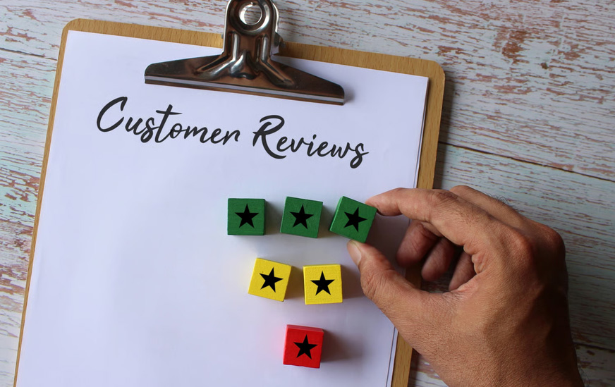 Clipboard displaying Customer Reviews title next to a hand placing star rating blocks for a hospice reputation management framework.